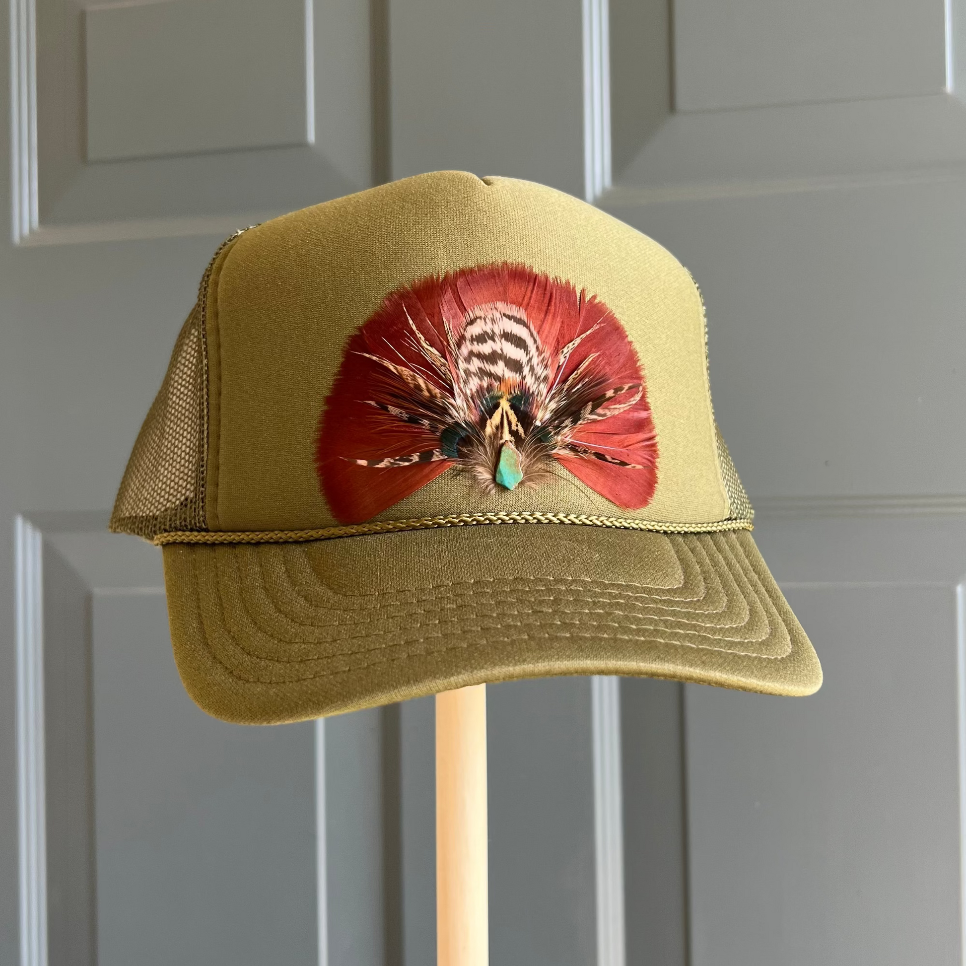 Green cap with a colorful design on a gray background